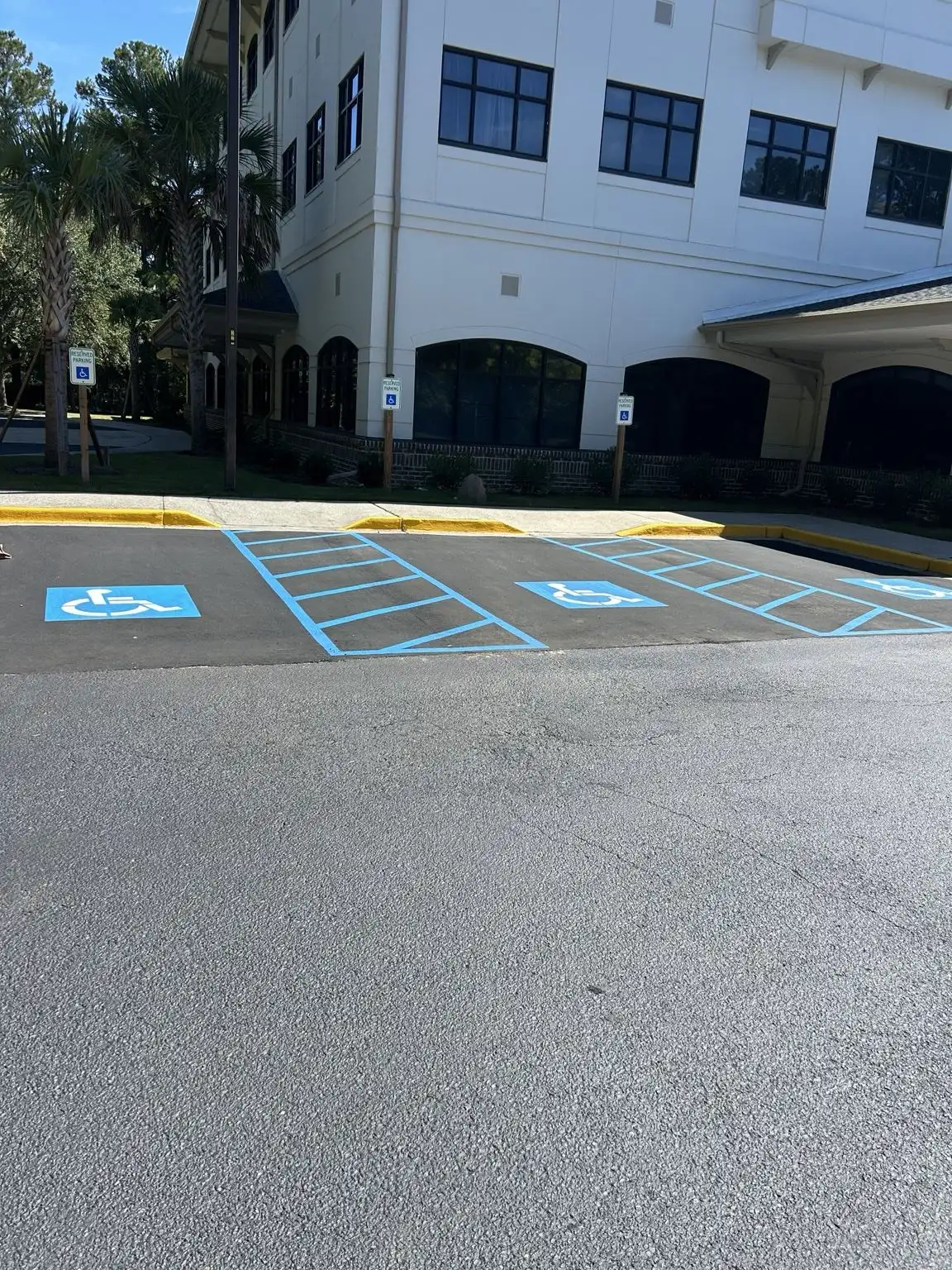ADA parking spaces and signs near a commercial building entrance
