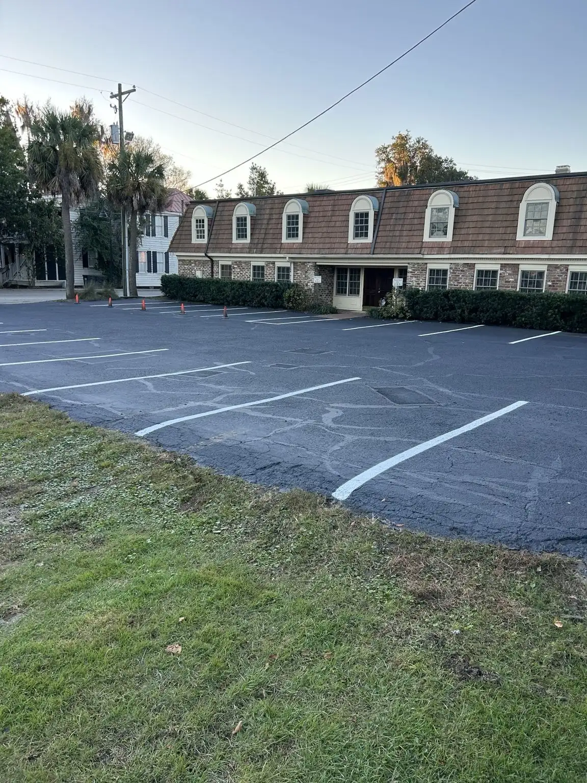 Office parking lot restriped with fresh white stall lines over maintained asphalt